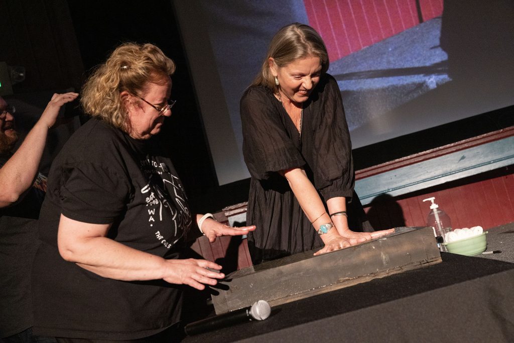 Sheryl Lee pressing hands into cement