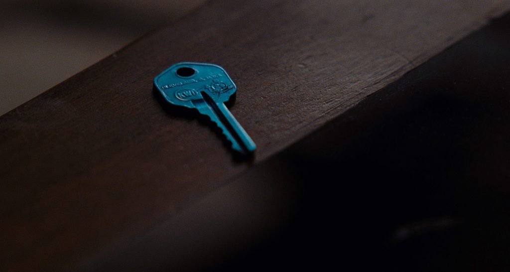 Blue key on a wooden table