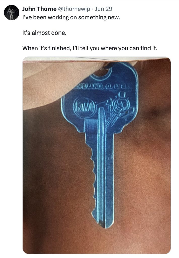 John holding a blue key