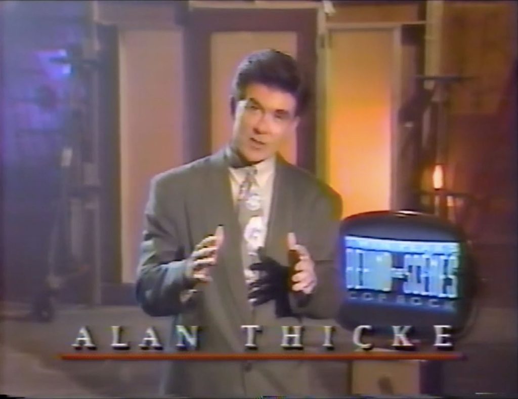 Host Alan Thick standing by a television