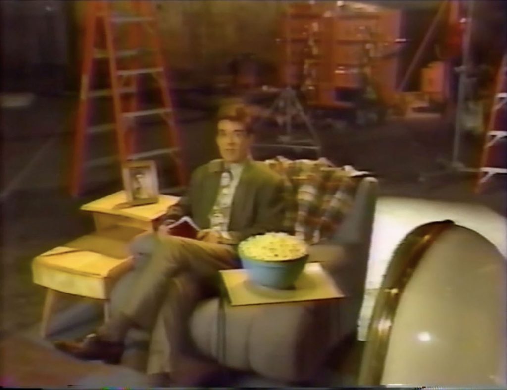 Alan Thicke sitting on a couch