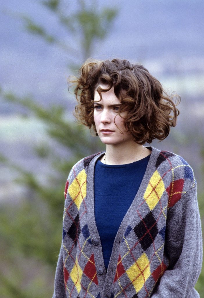 Donna Hayward wearing a cardigan sweater