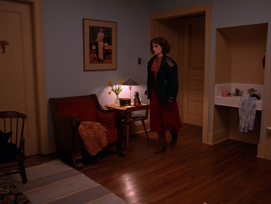 Donna Hayward walking through her bedroom