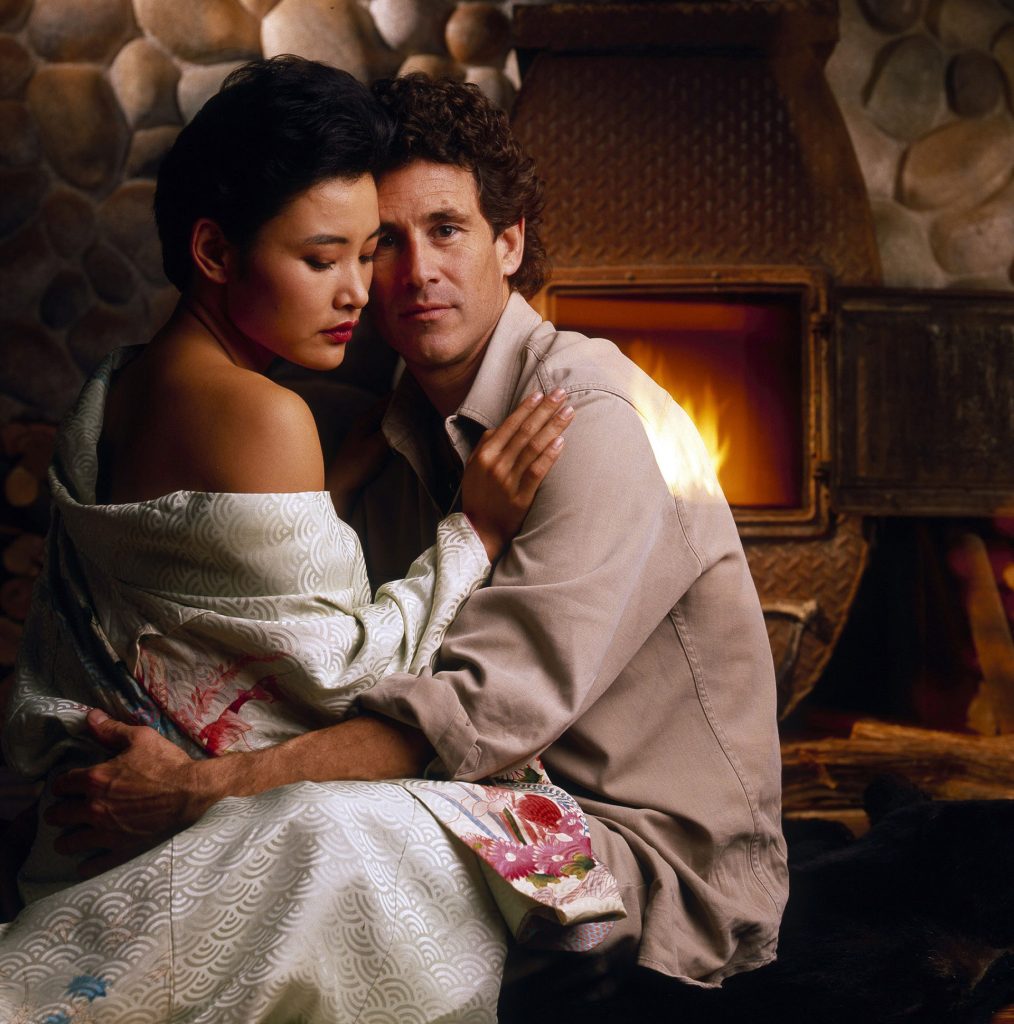 Josie Packard and Sheriff Truman by a fireplace