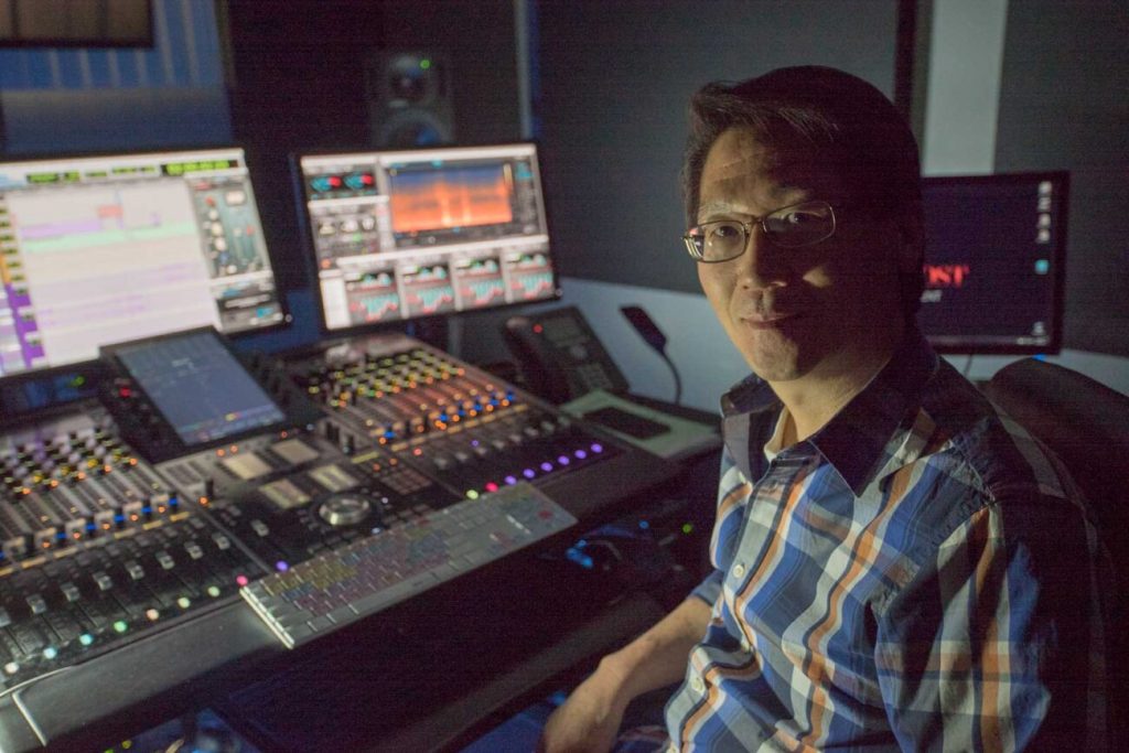 Peter Arata sitting at a mixing board