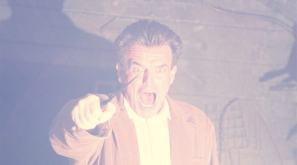 Leland Palmer holding a knife and yelling