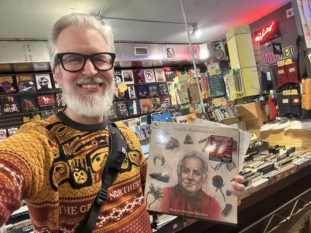 Steven holding a vinyl album in a record store