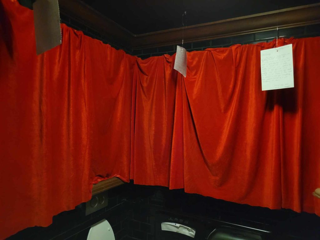 Red Drapes with hanging diary pages