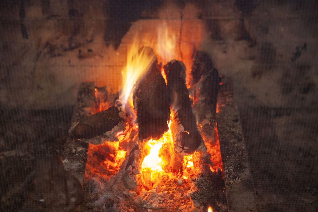 Logs on fire inside a fireplace