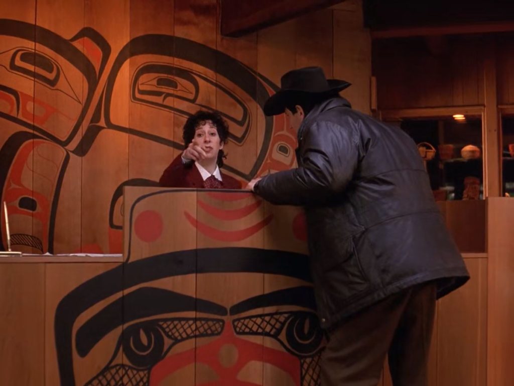 Sheriff Harry S. Truman asking the front desk employee the location of Leland Palmer.