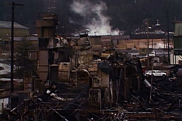 Morning after mill fire with smoking debris