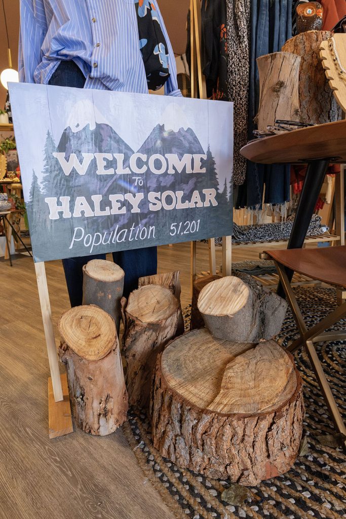 Welcome to Haley Solar sign next to logs