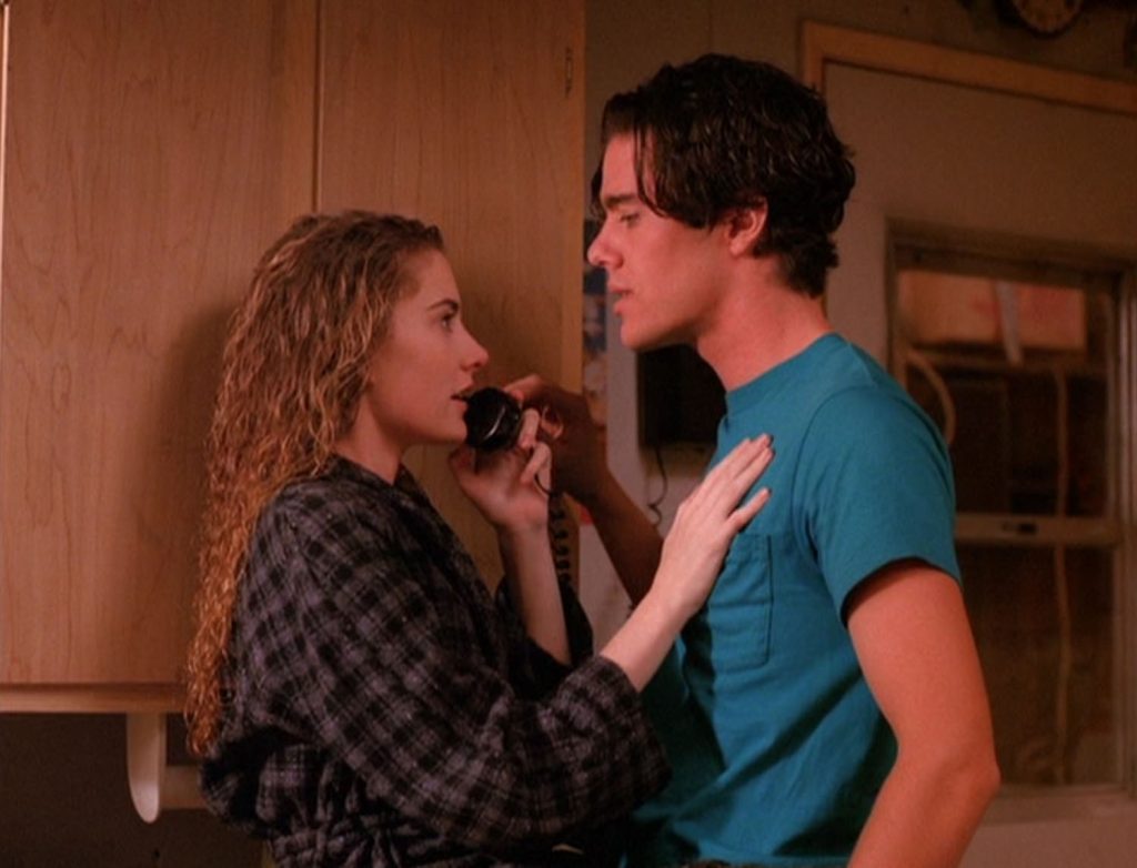 Shelly Johnson on the phone sitting on a counter next to Bobby