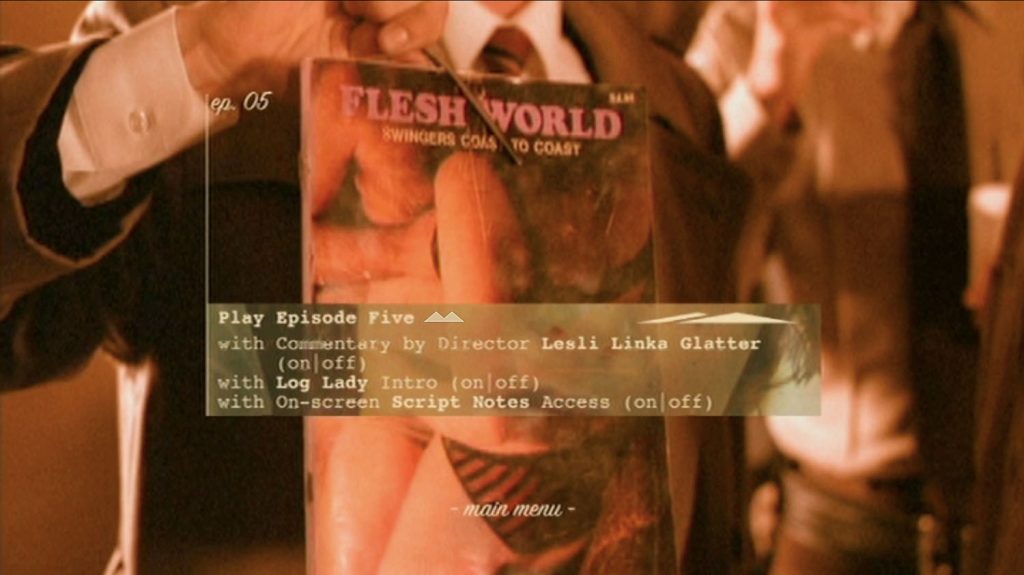 DVD Menu with an image of Agent Cooper holding up a copy of "Flesh World" magazine