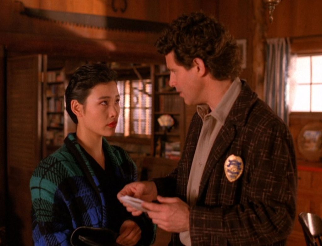 Josie Packard and Sheriff Truman discuss photos