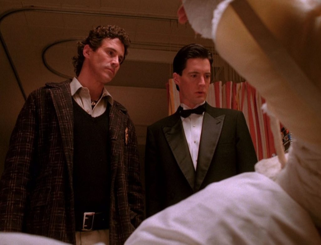 Sheriff Truman and Agent Cooper speaking with Jacques Renault in the hospital