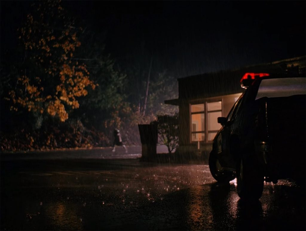 Leo Johnson running from Twin Peaks Sheriff's Department at Night in Rain