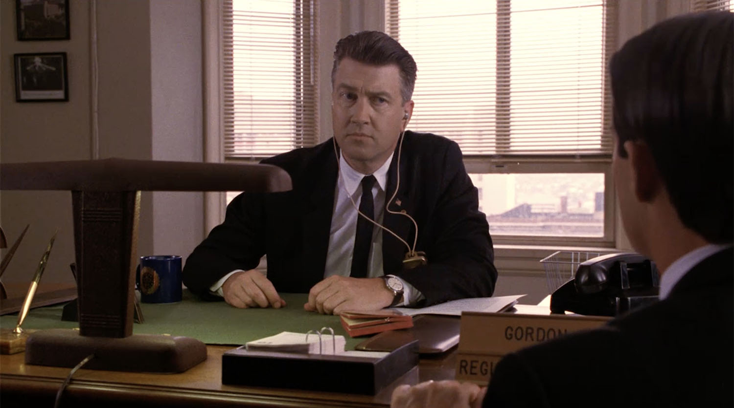 Gordon Cole sitting at his desk listening to Agent Cooper