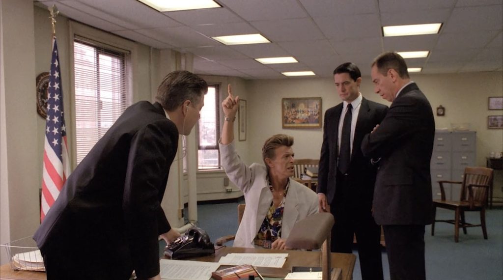 Gordon Cole listening to Phillip Jeffries as Cooper and Albert stand nearby