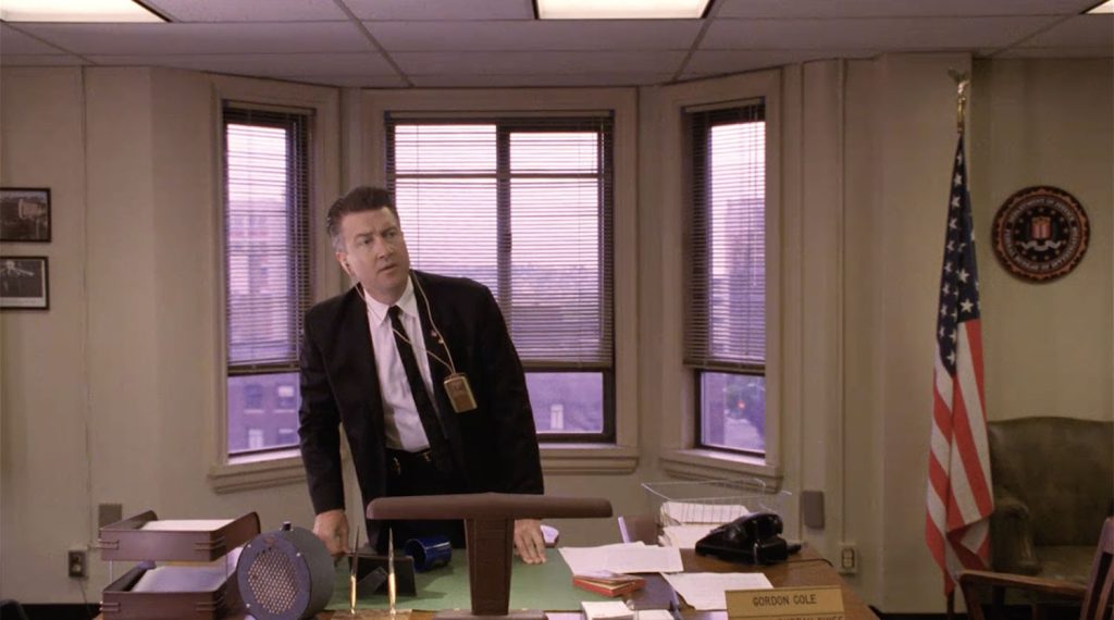 Gordon Cole standing at his desk