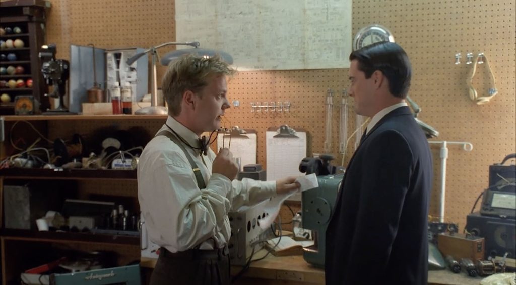 Agent Cooper speaks with Agent Stanley in his workshop