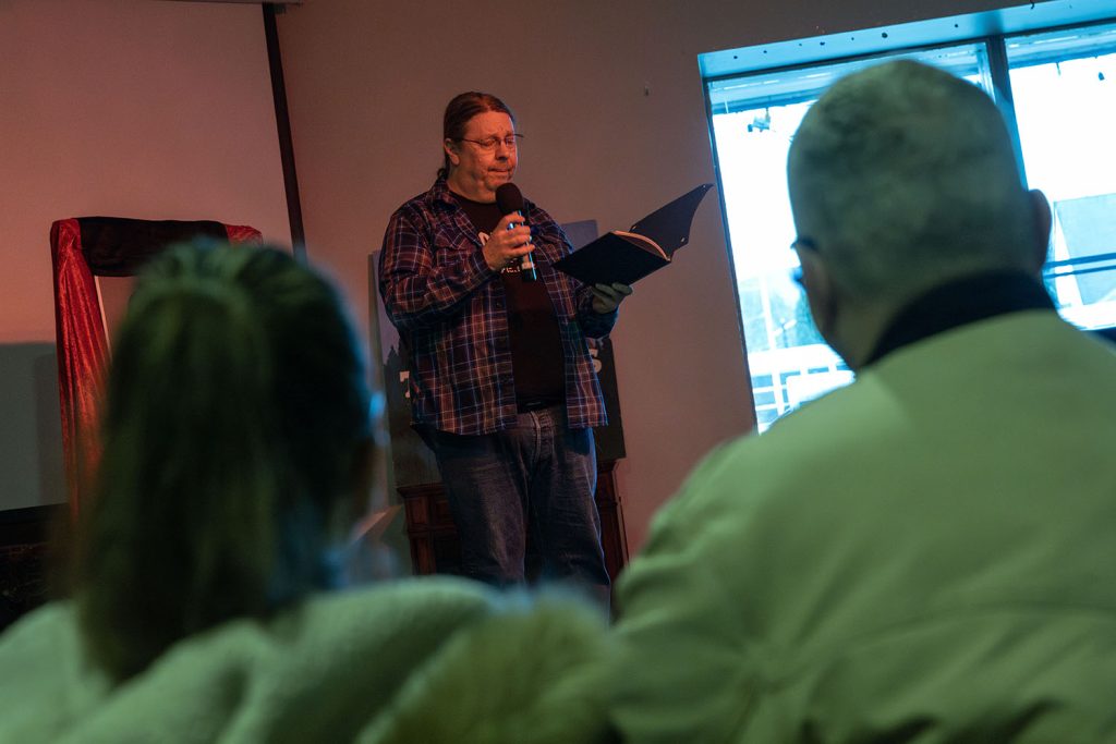 Karl Reinsch reading on stage