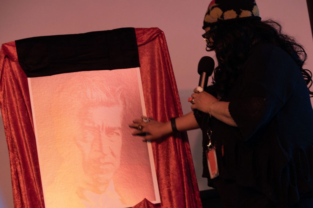 Rebekah Del Rio touching David's poster