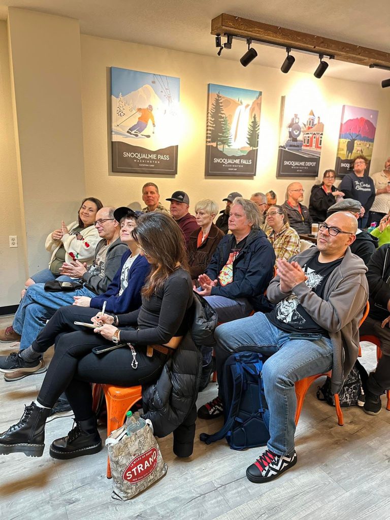 People listening to the panel discussion at Friends & Co. Ice Cream