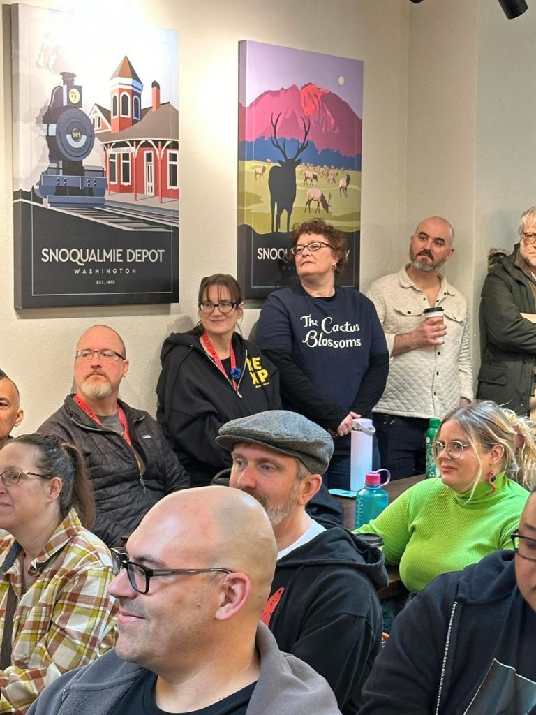 People listening to the panel discussion at Friends & Co. Ice Cream