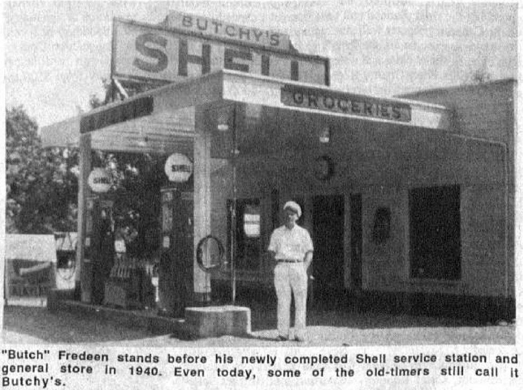 Black and White photo of a man standing outside a gas station named Butchy's