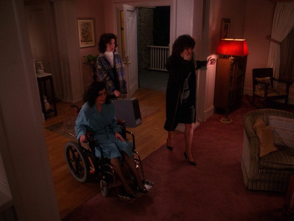 Donna Hayward leaving her home while family looks on