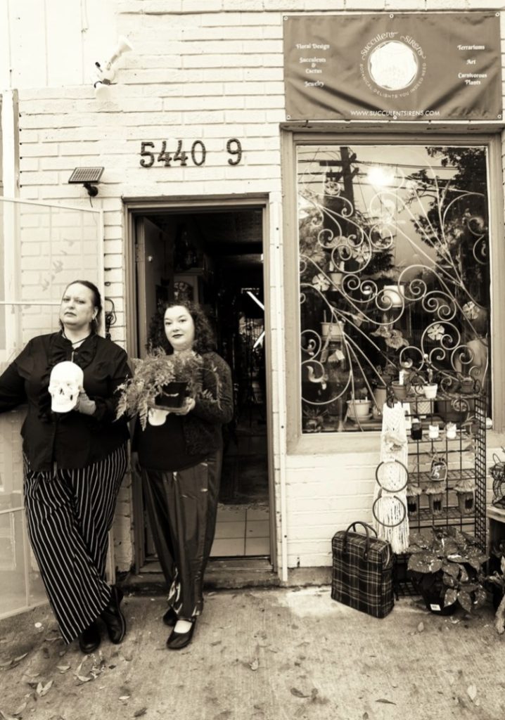 Sepia-tone image of two ladies standing by the entrance to a shot