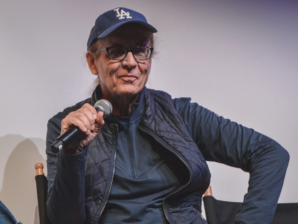 Mark Frost holding a microphone on stage