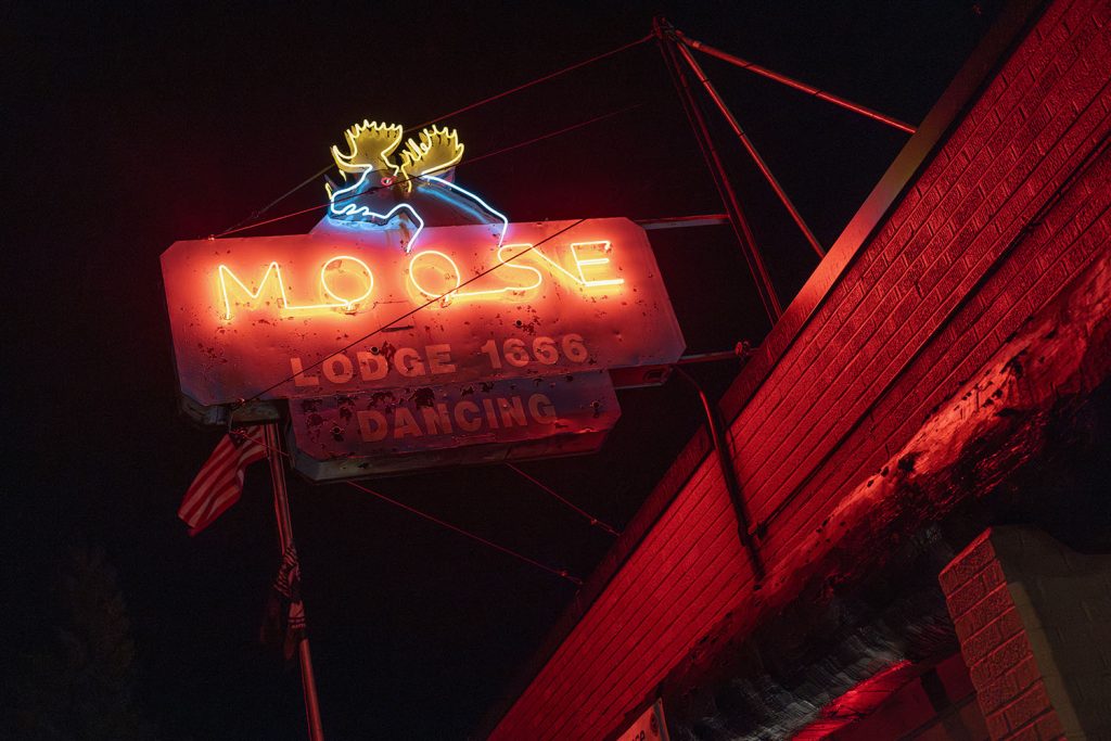 Neon sign for the Moose Lodge at night