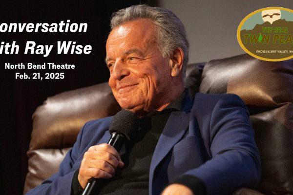 Ray Wise sitting in a chair smiling