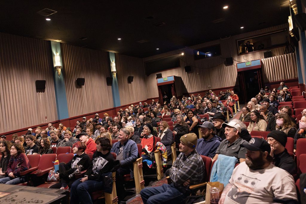 Theatre with audience watching Ray Wise and Mike McGraner speak