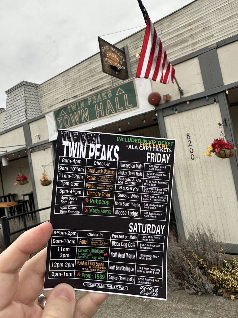 Holding up the schedule outside the Twin Peaks Town Hall