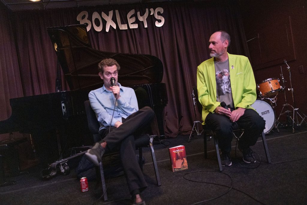 Josh and Scott speaking on stage at Boxley's