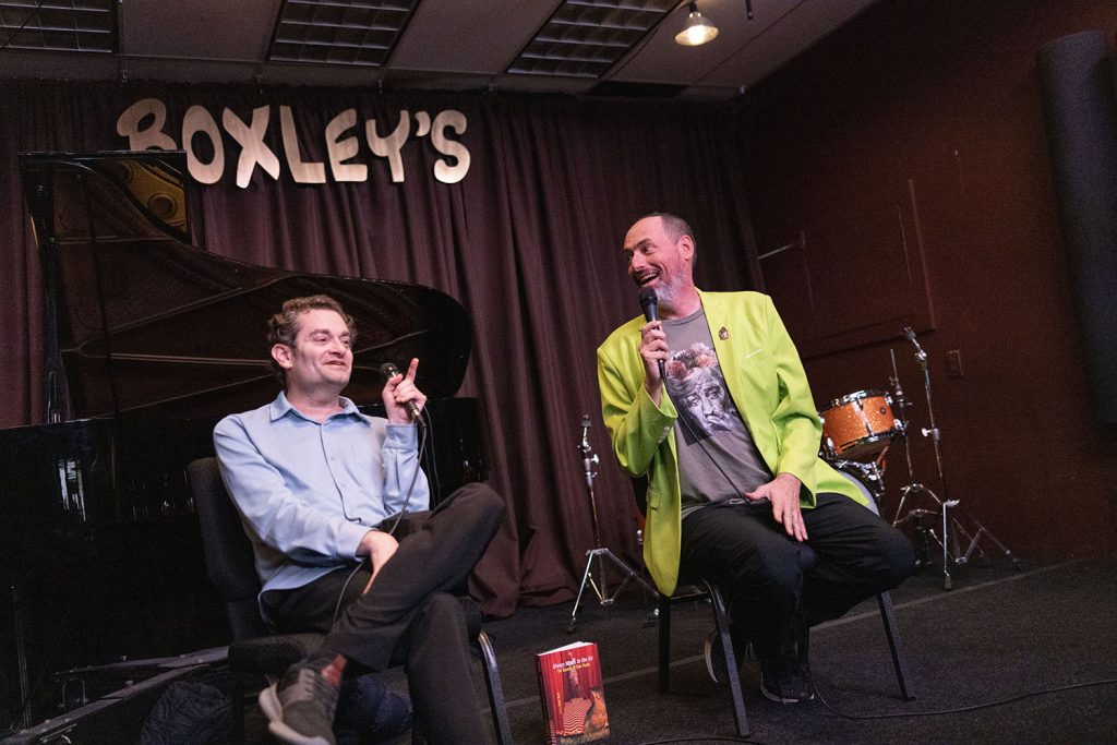 Josh and Scott speaking on stage at Boxley's