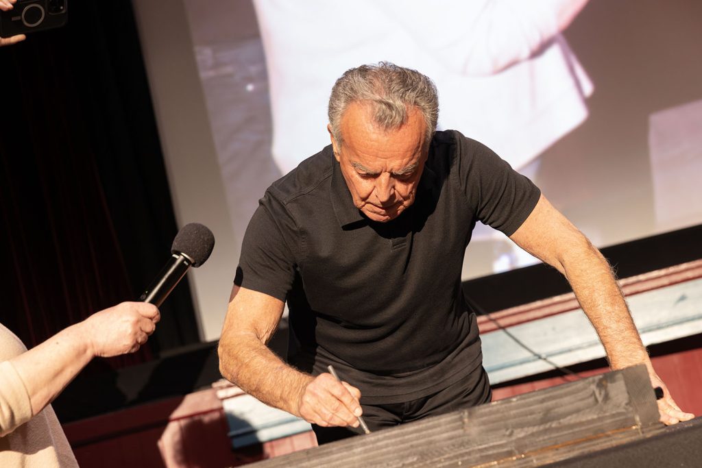 Ray Wise signing his name in cement