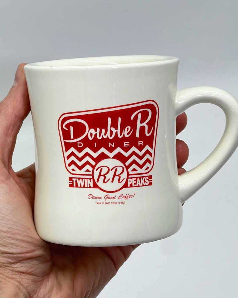 Double R Diner Mug behind held by a person