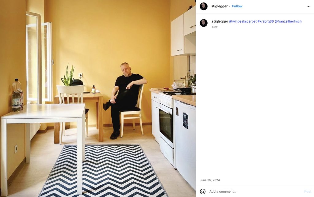 Dr. Stiglegger sitting in a ktichen with a chevron floor carpet