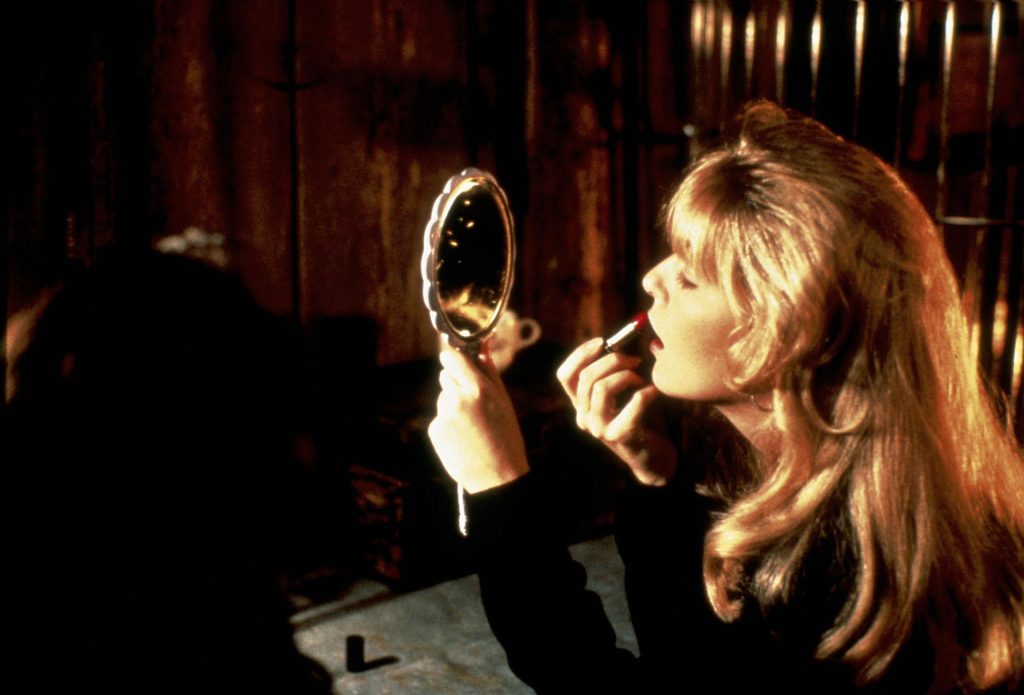 Laura Palmer putting on lipstick