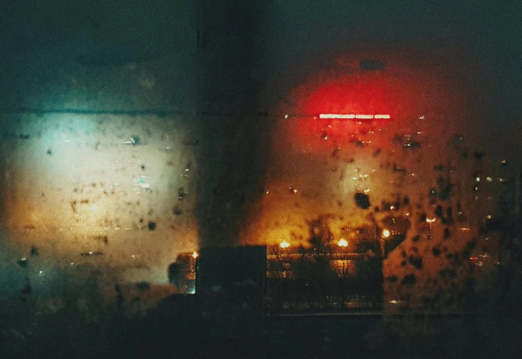 Night City in Fog through Window