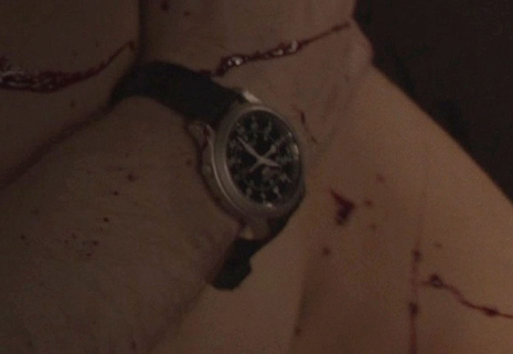 Detail of Sam's watch while Sam and Tracey are being attacked