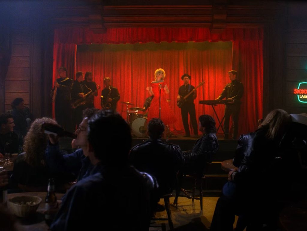 Julee Cruise performing on stage with a band