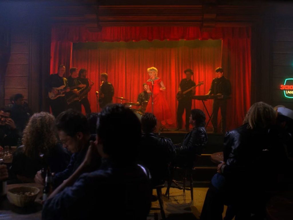 Julee Cruise performing on stage with a band