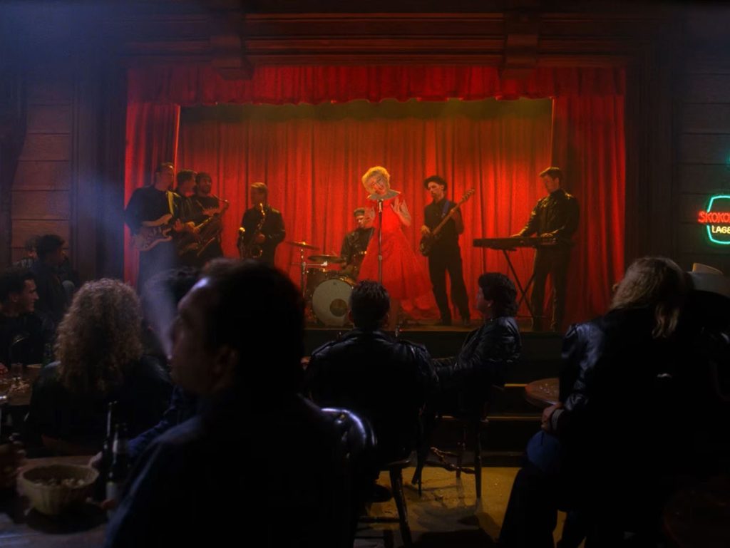 Julee Cruise performing on stage with a band