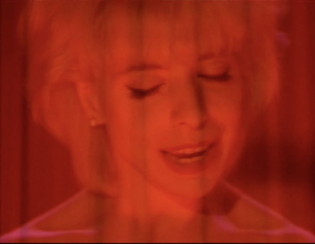 Red curtains superimposed over Julee's face