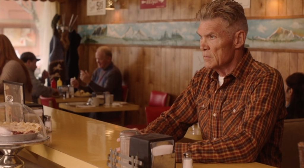 Big Ed seated at the counter